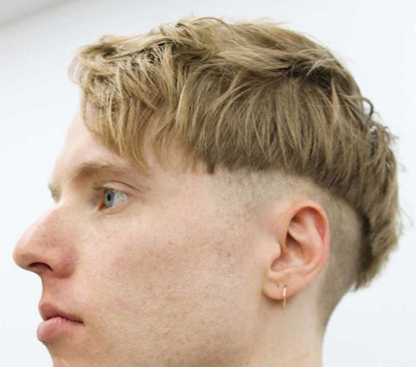10. Dirty Blonde Bowl Cut in Modern Style